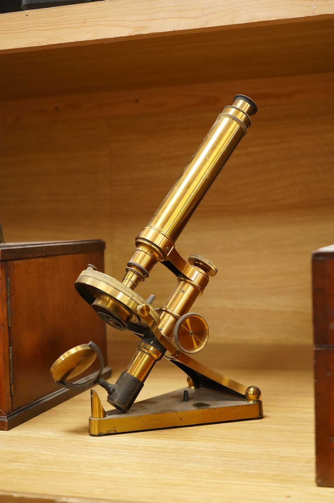 A late 19th century brass compound monocular microscope, by R and J. Beck, mahogany cased, with two objectives, 2 eyepieces and miscellaneous slides, the case dimensions; 40.5 x 15.5x 18cm, together with a small early 19